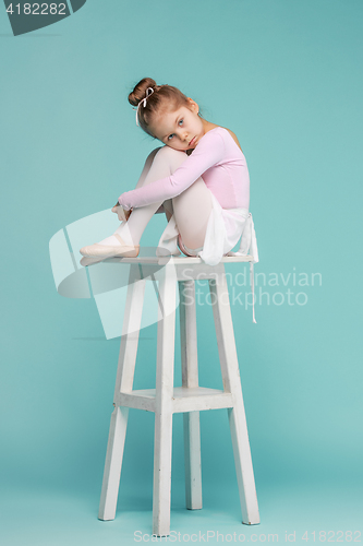 Image of The little balerina dancer on blue background