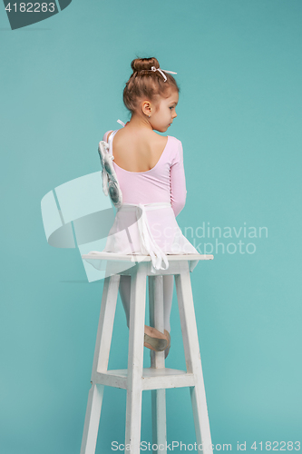 Image of The little balerina dancer on blue background
