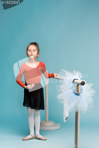 Image of The little balerina dancer on blue background