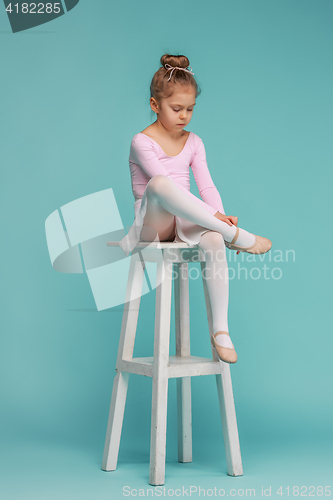 Image of The little balerina dancer on blue background