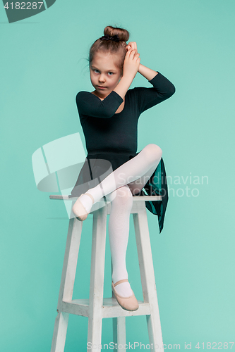 Image of The little balerina dancer on blue background