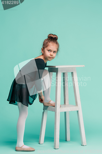 Image of The little balerina dancer on blue background