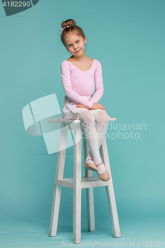 Image of The little balerina dancer on blue background