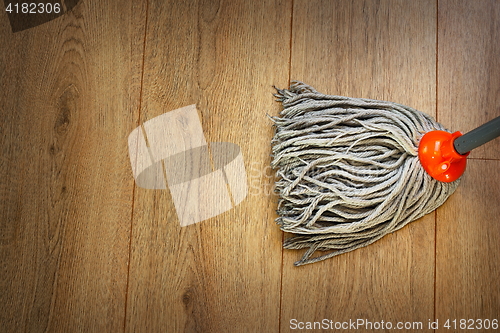 Image of detail of a mop on wooden parquet