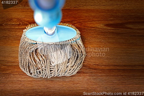 Image of wooden parquet cleaned with a mop