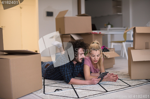 Image of Young couple moving in a new flat