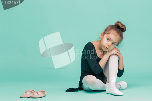 Image of The little balerina dancer on blue background