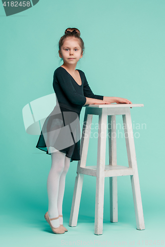 Image of The little balerina dancer on blue background