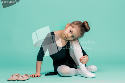 Image of The little balerina dancer on blue background