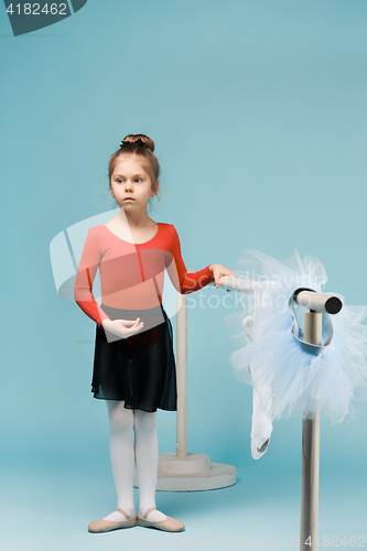 Image of The little balerina dancer on blue background
