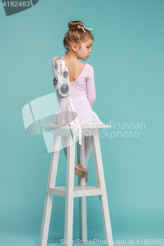 Image of The little balerina dancer on blue background