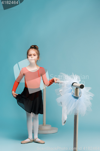 Image of The little balerina dancer on blue background