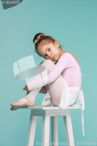 Image of The little balerina dancer on blue background