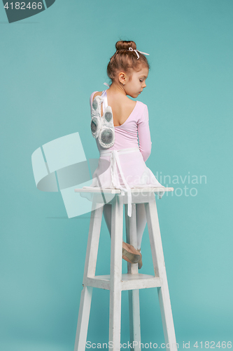 Image of The little balerina dancer on blue background