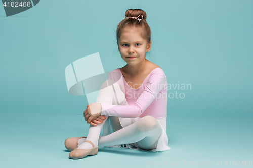 Image of The little balerina dancer on blue background