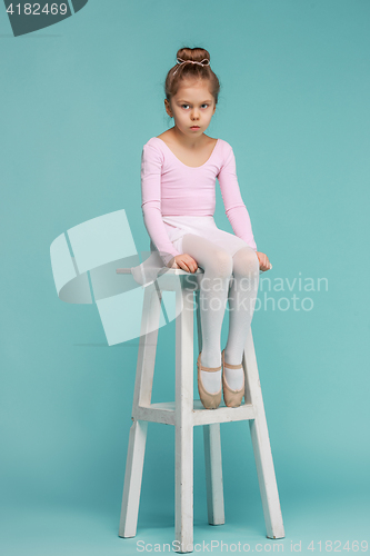 Image of The little balerina dancer on blue background