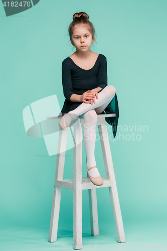 Image of The little balerina dancer on blue background