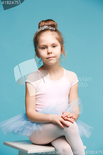 Image of The little balerina dancer on blue background