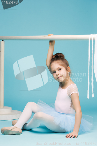 Image of The little balerina dancer on blue background