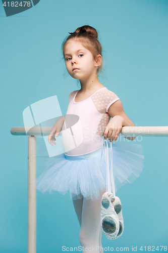 Image of The little balerina dancer on blue background