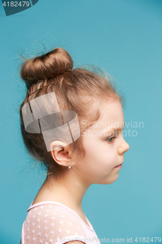 Image of Cute little girl on a blue background close-up