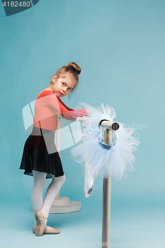 Image of The little balerina dancer on blue background