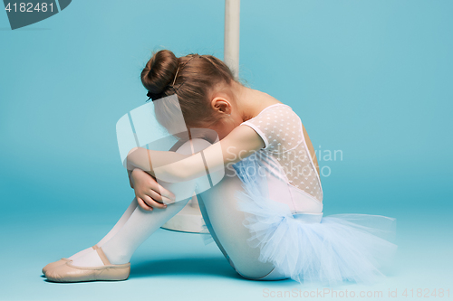 Image of The little balerina dancer on blue background