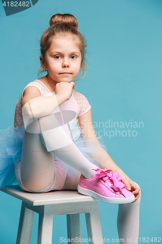 Image of The little balerina dancer on blue background