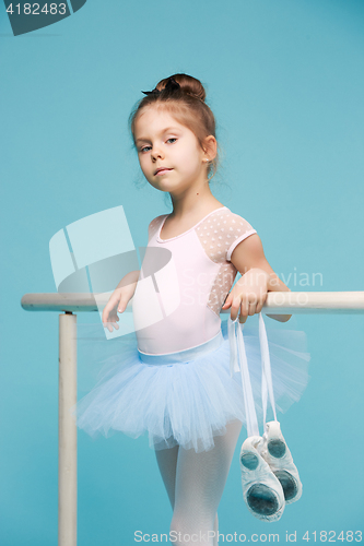 Image of The little balerina dancer on blue background