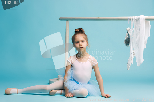 Image of The little balerina dancer on blue background