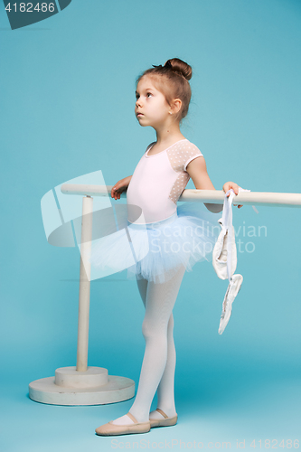 Image of The little balerina dancer on blue background