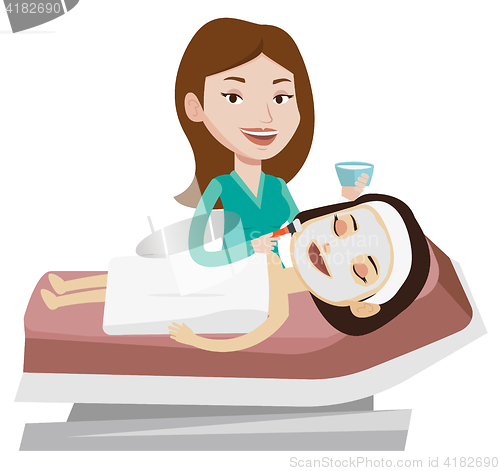 Image of Woman in beauty salon during cosmetology procedure