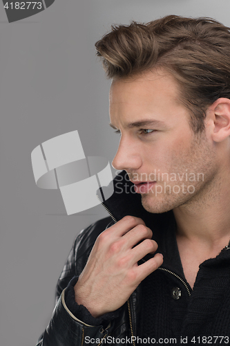 Image of portrait of a young guy over gray background