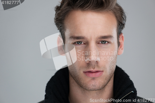 Image of portrait of a young guy over gray background