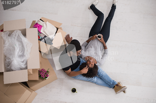 Image of African American couple relaxing in new house