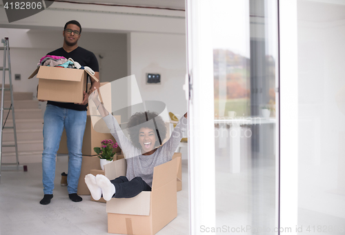 Image of African American couple  playing with packing material
