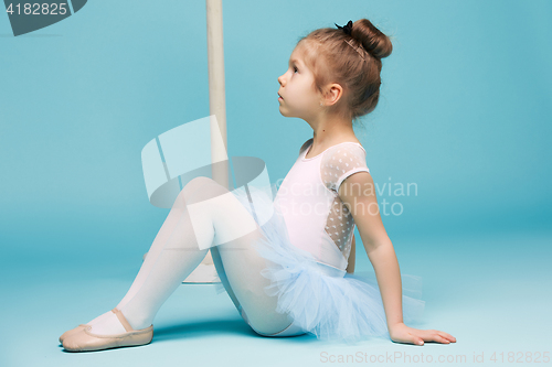 Image of The little balerina dancer on blue background