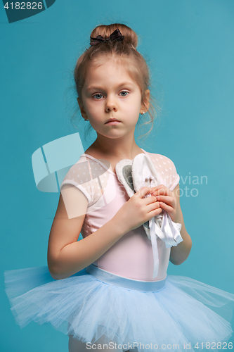 Image of The little balerina dancer on blue background