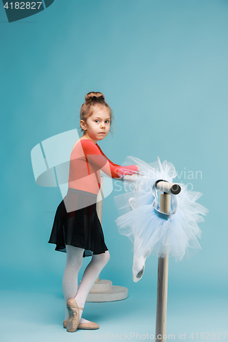 Image of The little balerina dancer on blue background