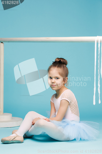 Image of The little balerina dancer on blue background