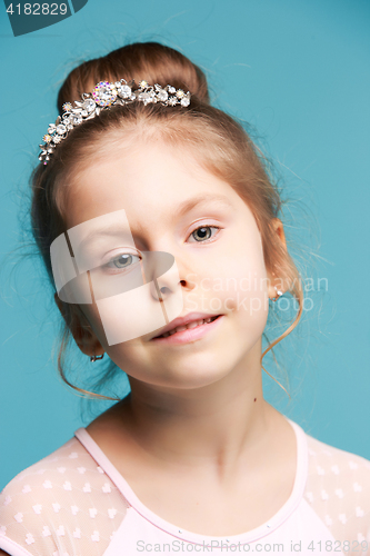 Image of Cute little girl on a blue background close-up