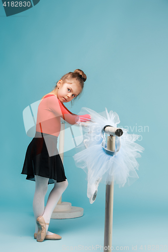 Image of The little balerina dancer on blue background