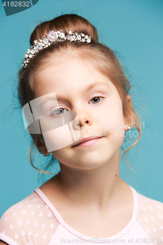 Image of Cute little girl on a blue background close-up