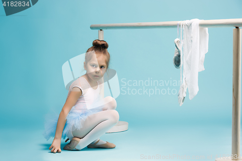 Image of The little balerina dancer on blue background