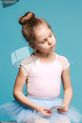 Image of The little balerina dancer on blue background