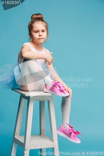 Image of The little balerina dancer on blue background