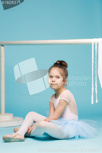 Image of The little balerina dancer on blue background
