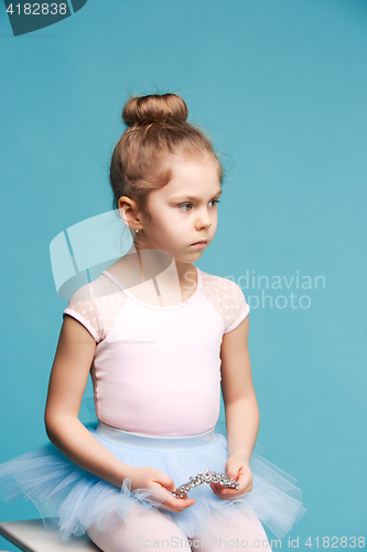 Image of The little balerina dancer on blue background