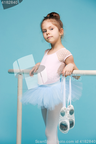 Image of The little balerina dancer on blue background