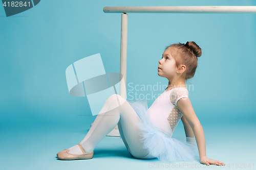 Image of The little balerina dancer on blue background